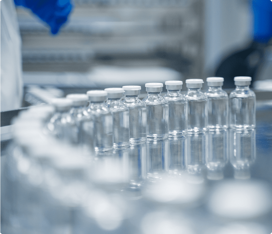 Vials aligned on reflective laboratory surface.